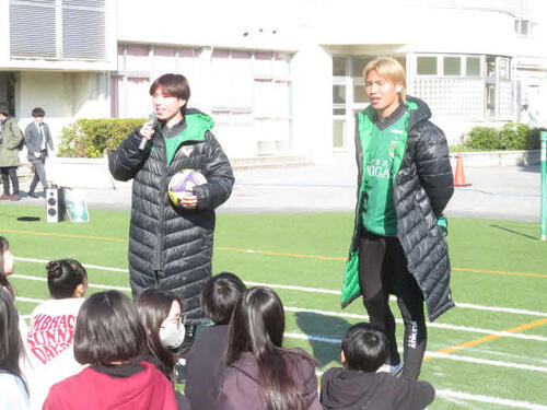 校庭でマイクを手に話をする東京Vの深澤大輝（左）と稲見哲行