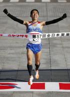 笑顔でゴールする、コニカミノルタの松宮隆行(共同)